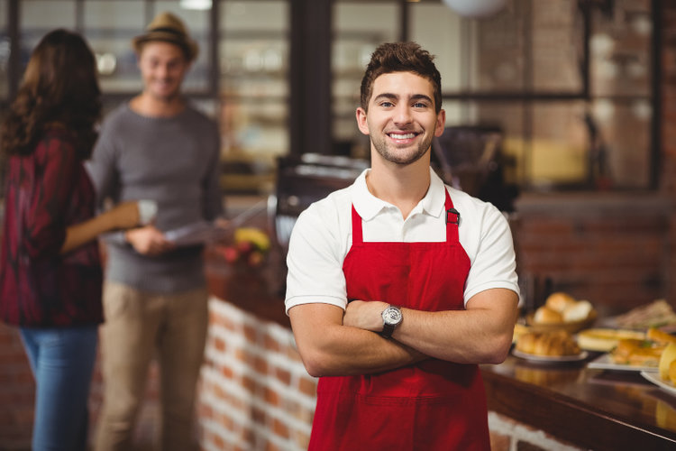 waiter wearing red apron