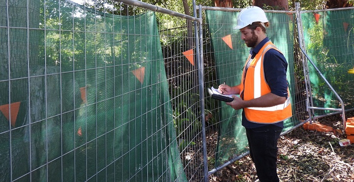 man writing a tree inspection report