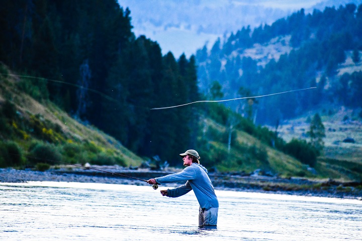 guy fishing while standing in water