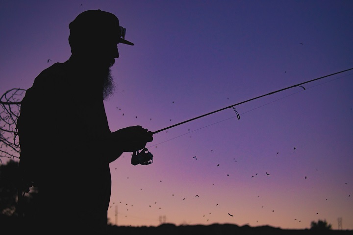 guy fishing in sunset