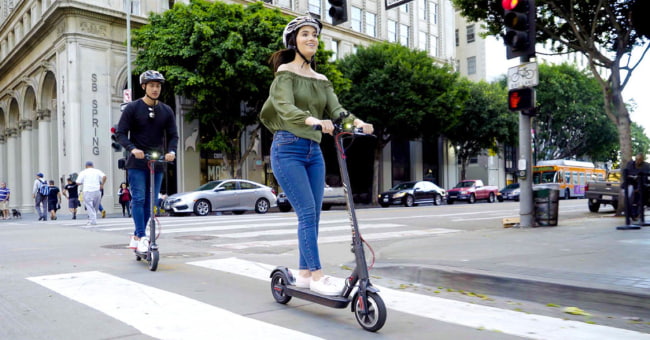 girl and boy riding electric scooters