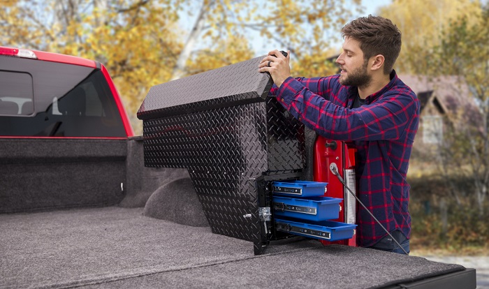 picture of a man beside his truck with a side mount aluminum toolbox storage