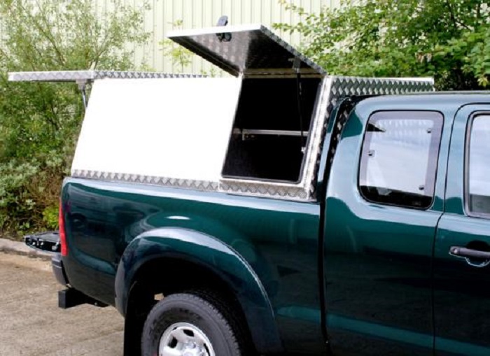 picture of aluminum canopies with side opening doors on a green truck