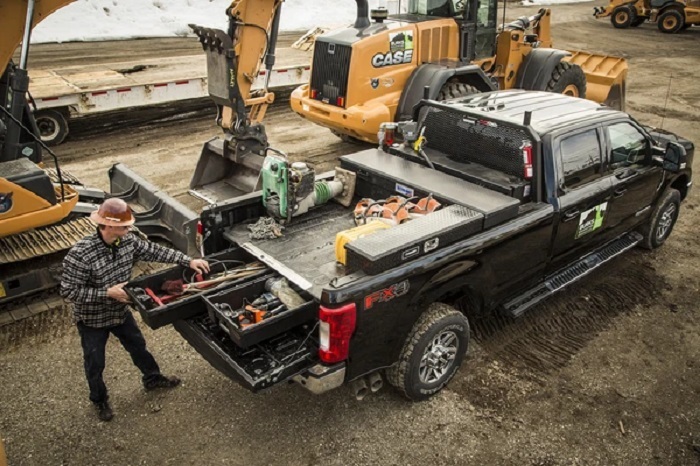 picture of a man working on a construction field with his truck with storage