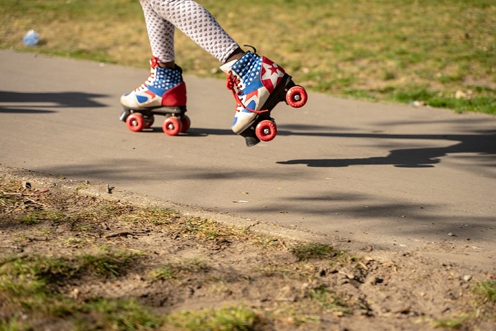 picture of a little girl in a leggings with hearts and roller skates with the American flag 