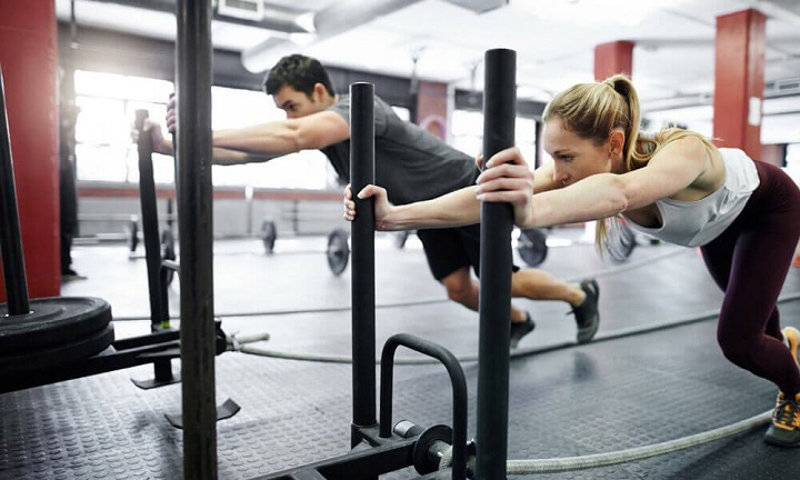 couple doing workout with gym sleds