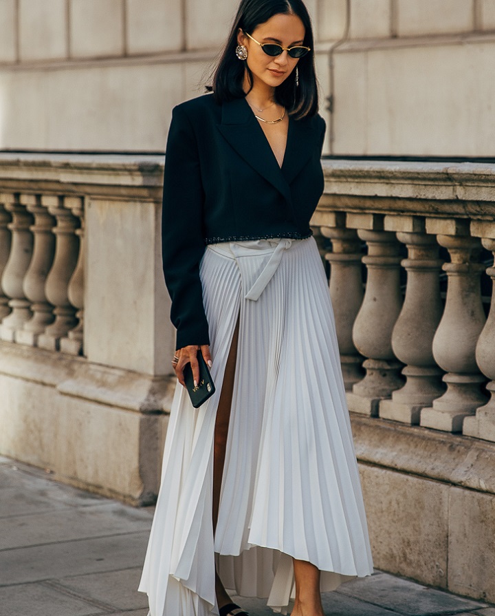 picture of a stylish woman walking beside building 