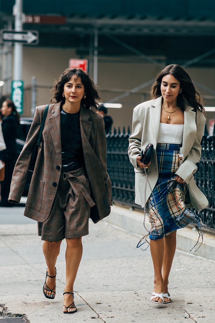 picture of two stylish women walking on the sidewalk