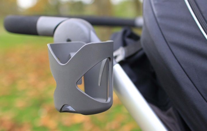 picture of a cup holder on a pram in the park