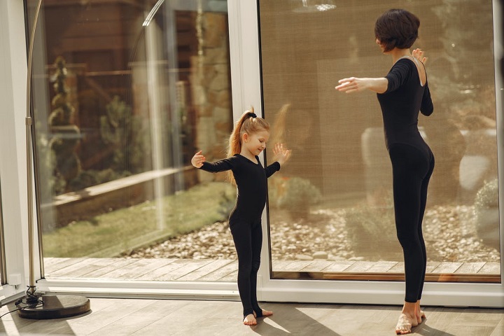 picture of mother and daughter practecing dance moves wearing basic leotards 
