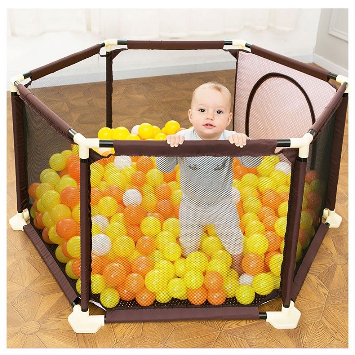 picture of a baby in a playpen with plastic balls