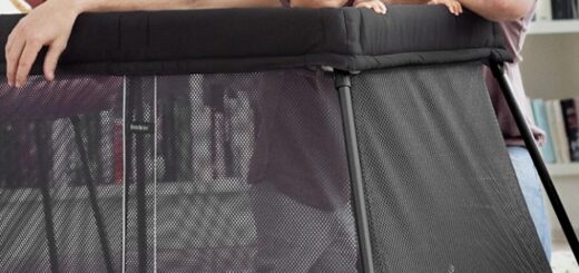 picture of a men beside a baby in a playpen