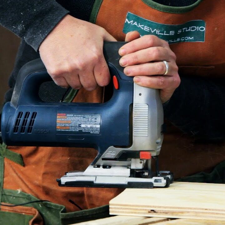 A man working with jigsaw wood cutting machine