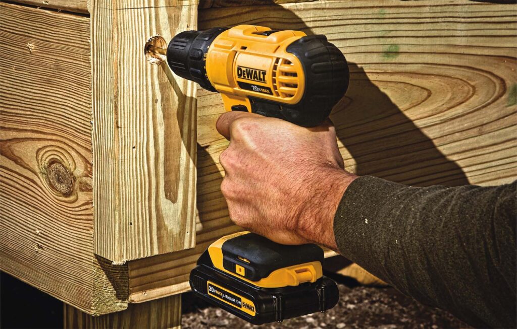 A man working with screw gun 