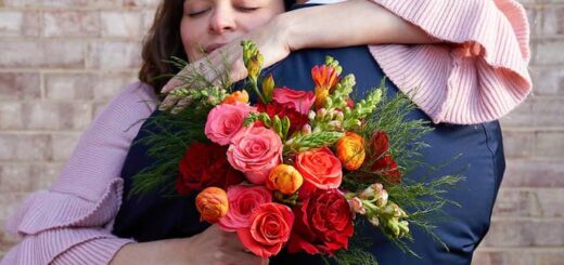 Girl is holding bouquet while holding her boyfriend