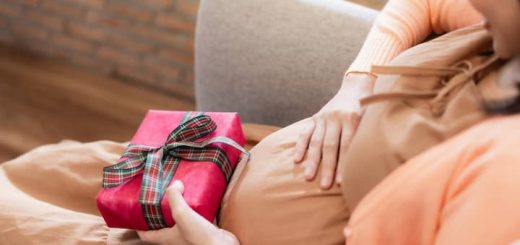 Pregnant Woman is holding gift