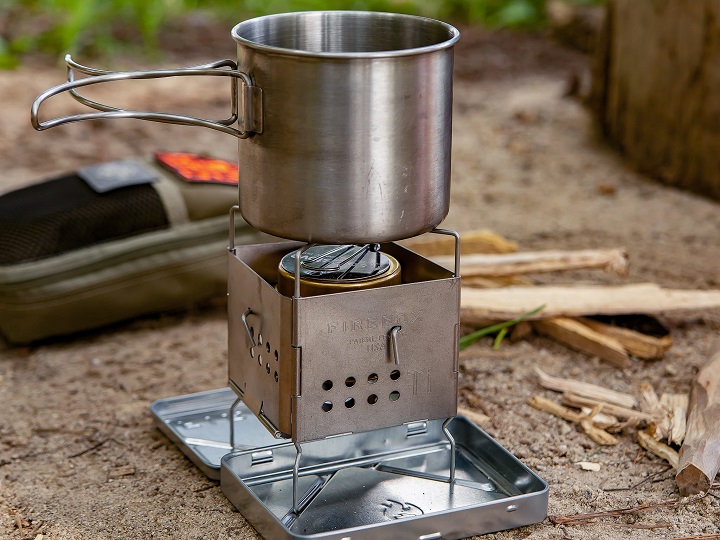 Firebox stove with pot on it in nature