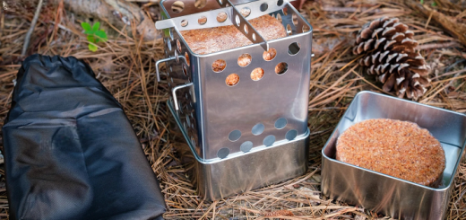 Firebox stove on the ground by the backpack