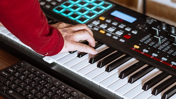 person playing a digital synthesizer