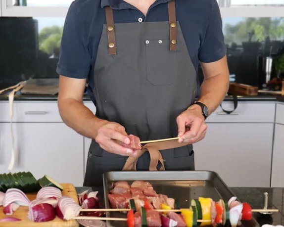 man cooking in apron