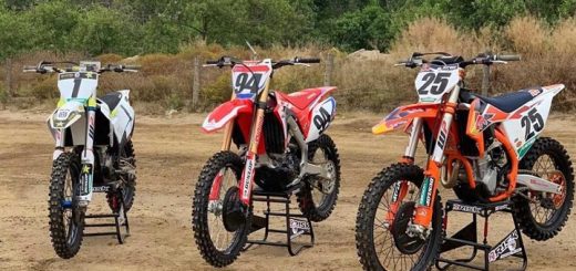 Three dirt bikes on stands