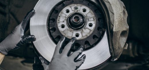 person changing car brakes